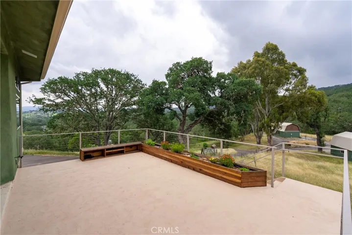 Lovely planter box and sitting area with convenient watering ability.