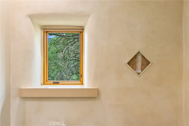 Bedroom 2 showcases a framed peek into the straw built construction material used in the home.