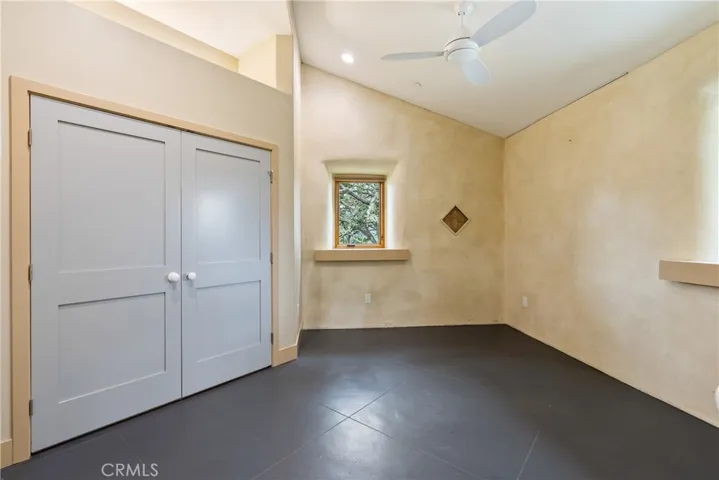 Bedroom 2 has a Venetian plaster accent wall, lighted reach-in closet, and ceiling fan.