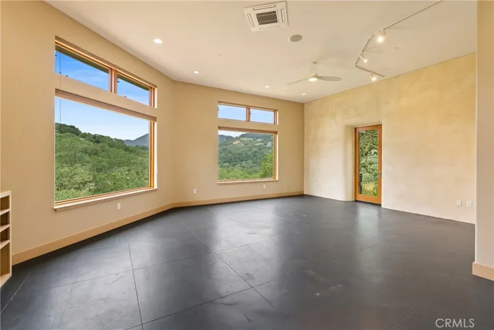 The living room is spacious and features a striking accent wall finished with Venetian plaster.
