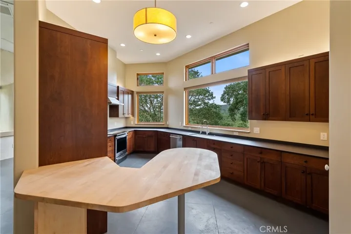 Cozy kitchen with beautiful wood cabinetry, soft-close drawers and pullouts. The butcher block breakfast bar is ~5'.