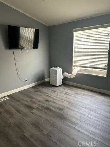 Master bedroom showing A/C and TV included.