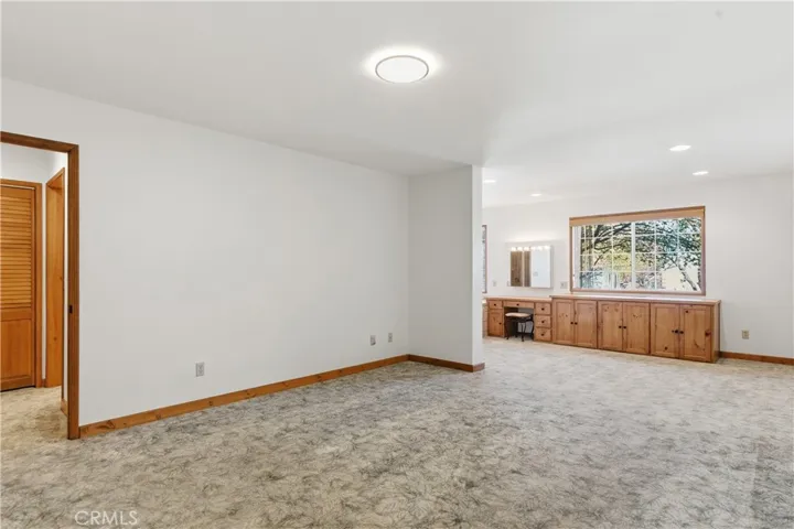 Spacious Primary Bedroom, with convenient wood cabinet space and vanity area