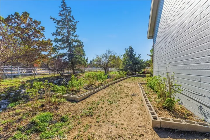 Side of Home has planted landscaped areas
