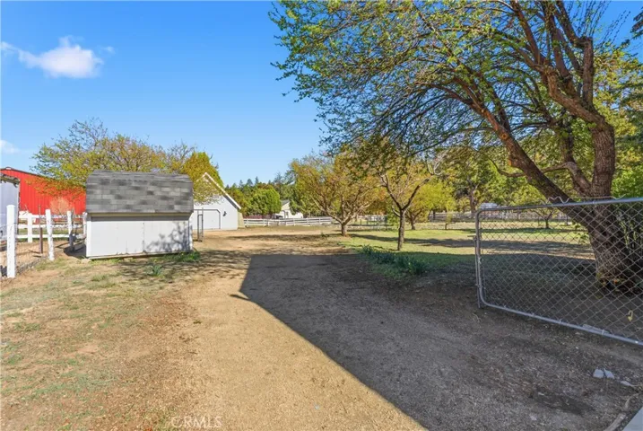 Large backyard with shed, garage, horse corral and chicken coop.  Lovely trees and lots of room for parking and toys!