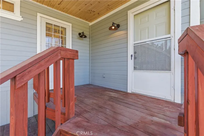 Backyard Porch with attractive exterior lights.  One of the doors is from Master Bedroom and the other from Hallway near Laundry Area