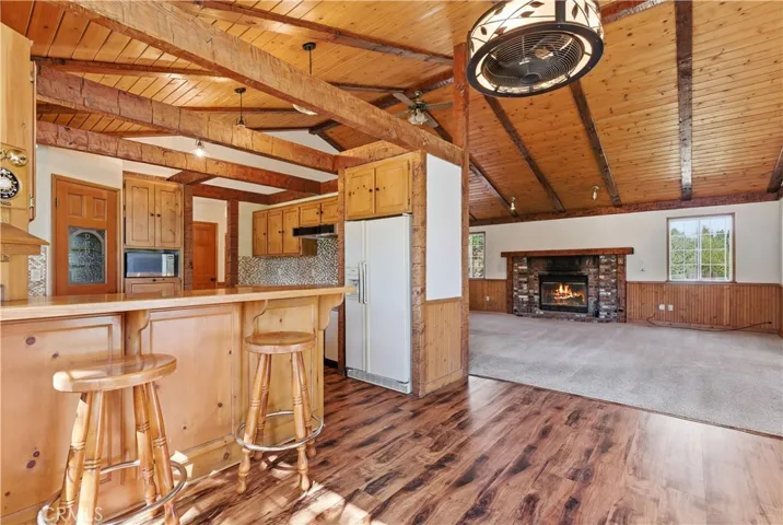 Dining area opens to spacious Living Room with brick fireplace.
