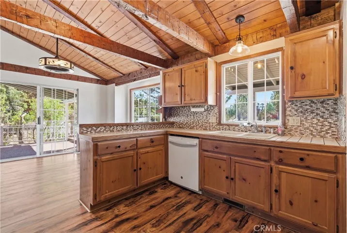 Open kitchen with wood beamed ceilings