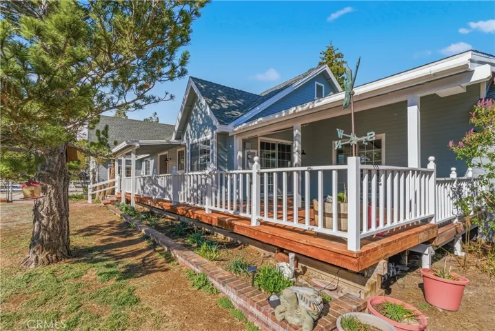 Covered side deck overlooking beautiful landscape.