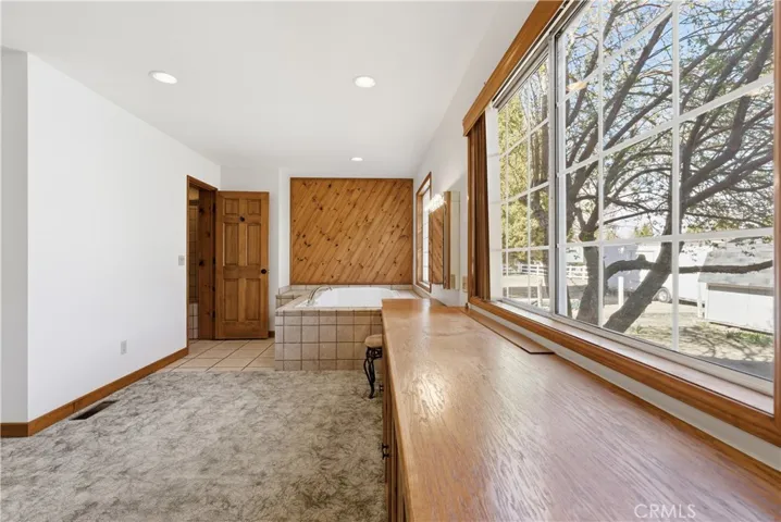 Primary Bedroom with plenty of windows filtering in all the natural light near Master Bath