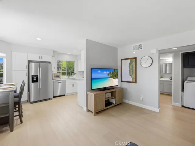 Family room open to kitchen/nook (TV digitally enhanced)