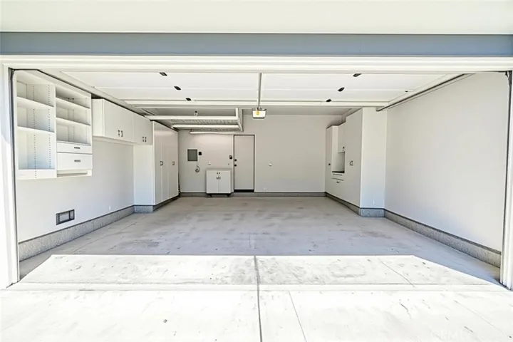 Garage with lots of storage and work area.