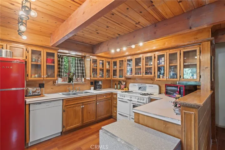 Custom pine cabinets with glass doors, Formica counters.