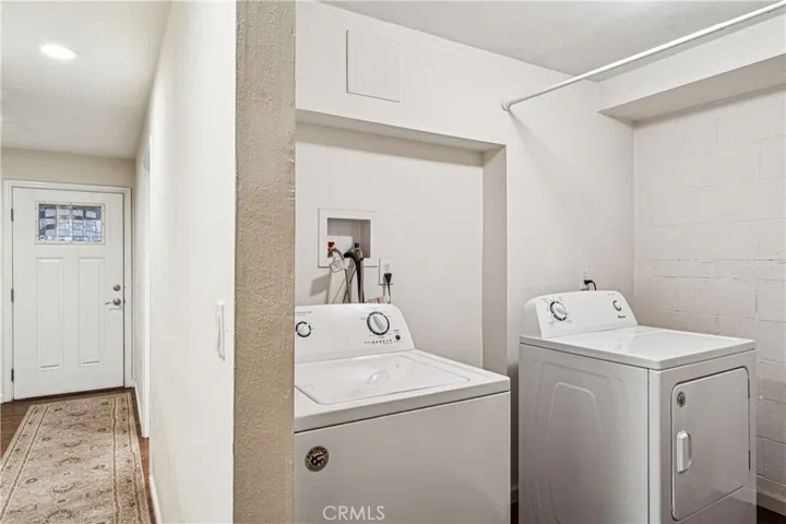 Laundry room & Hallway to Main Floor Primary Bedroom & Bathroom
