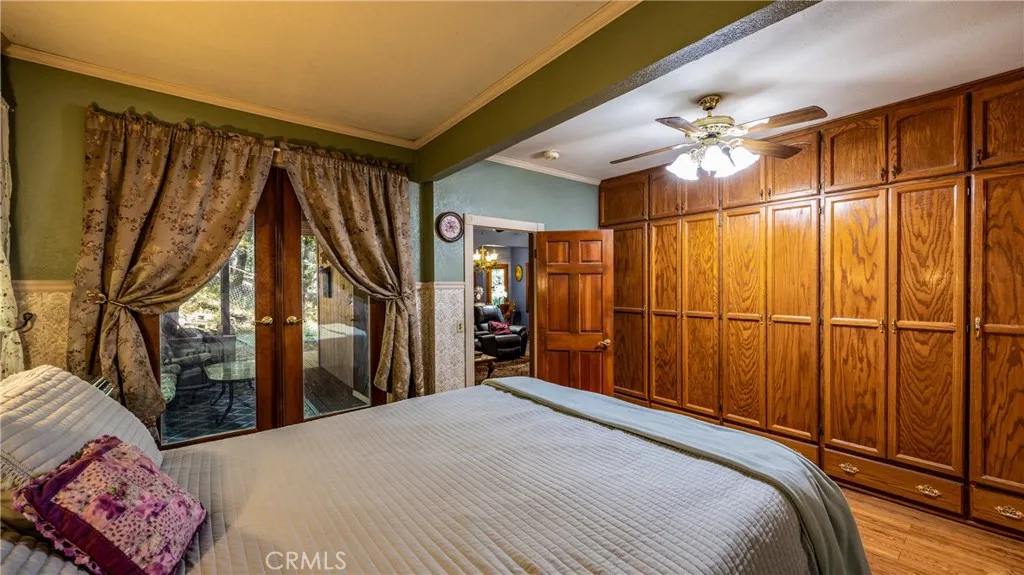primary bedroom with built in closet wall