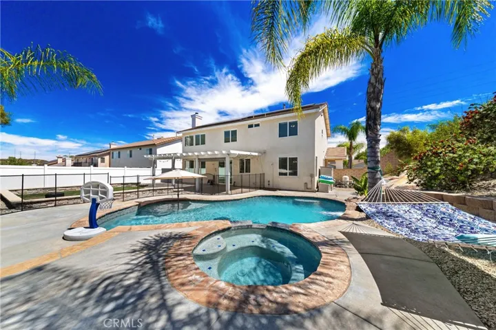 Backyard Oasis With Rock Water Feature And Pool