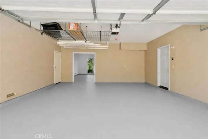 The garage features an EV charger, painted floor &  hanging storage racks