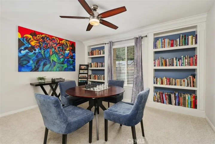 Generously sized loft with ceiling fan & built-in shelves