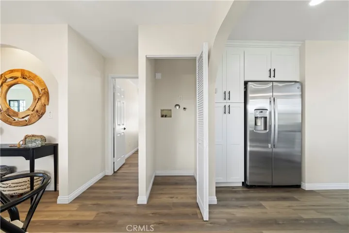 Laundry closet with hallway to master bedroom on left