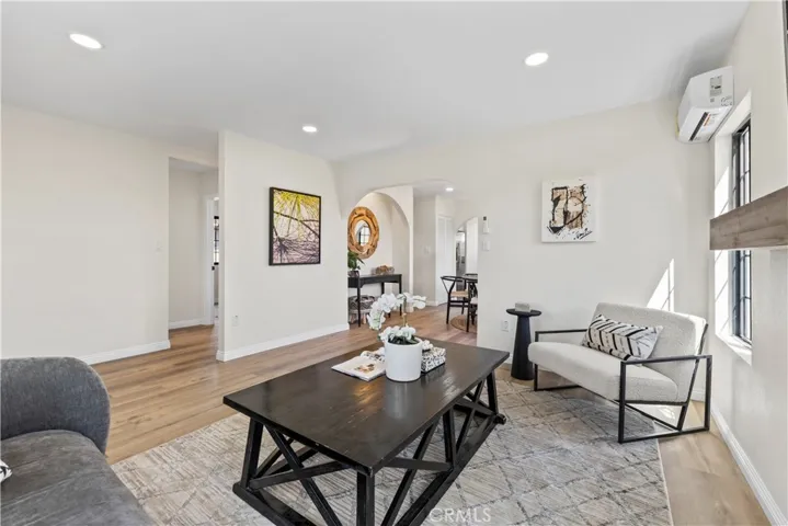 Family room facing hallway to bedrooms on left and dining room through archway