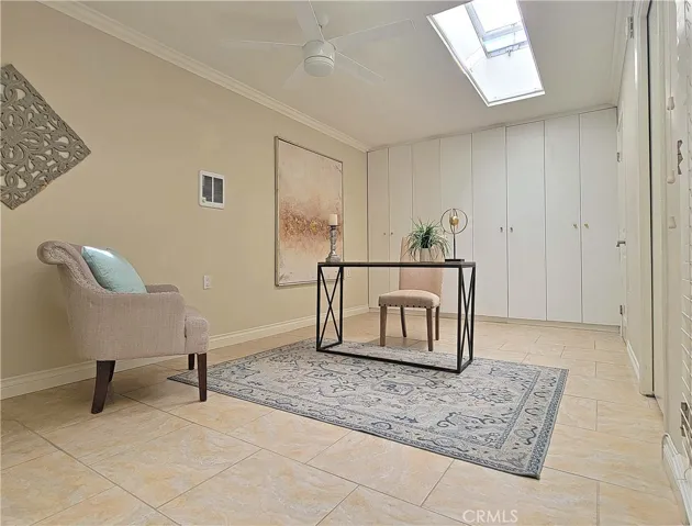 Expanded second bedroom with skylights currently staged as an office.