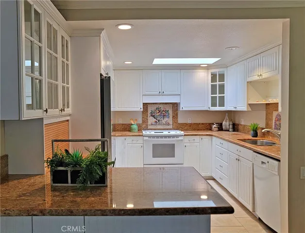 Updated kitchen with skylights and granite countertops.