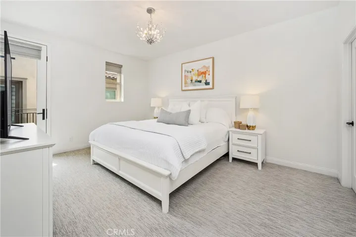 Primary Bedroom is Large! Filled with natural light and has a balcony.