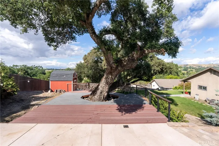 Expansive Trex deck wraps around a beautiful oak tree