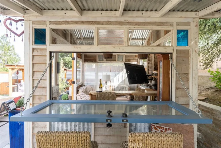 Clever she shed design with a drop-down door that becomes an outdoor bar