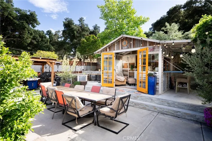 ne of several inviting outdoor spaces—ideal for dining and enjoying the she shed