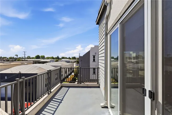 Balcony off of the living room with stairs to the rooftop deck