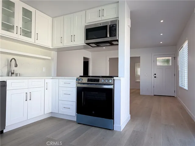 view from kitchen to living room to main entrance 
