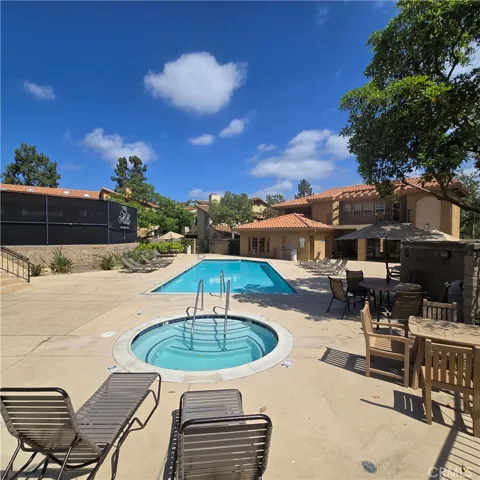 Communiyy pool area next to tennis court