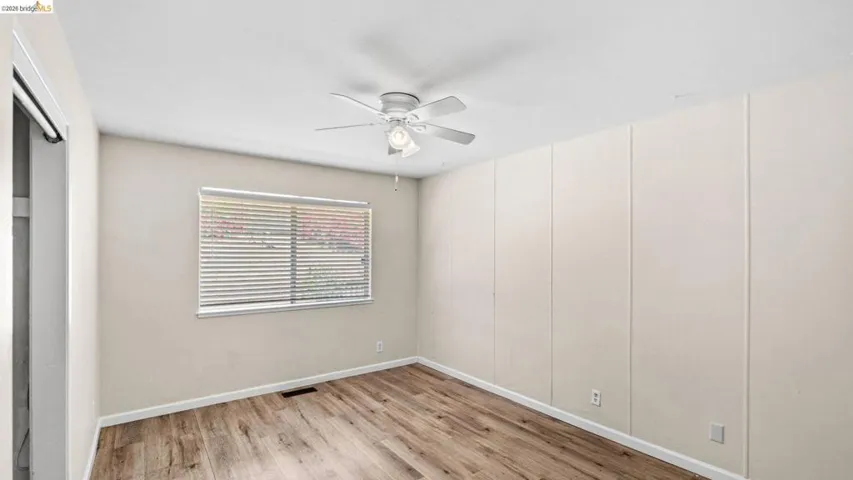Unfurnished bedroom with light wood-type flooring and a ceiling fan