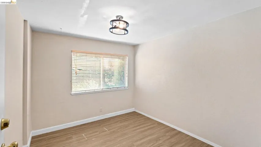 Unfurnished room featuring light wood-style floors and baseboards