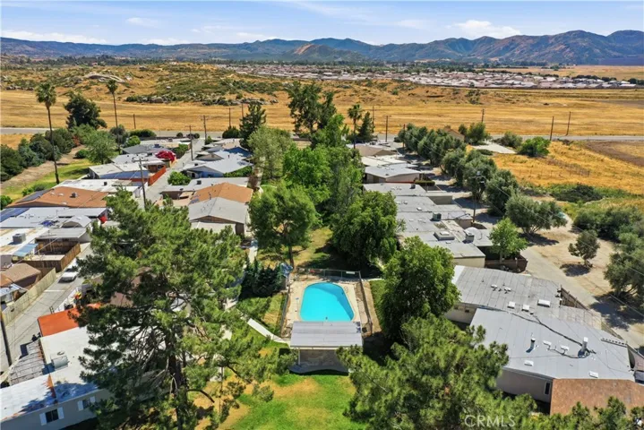 Overhead of community pool and park area showing trees throughout the center greenbelt