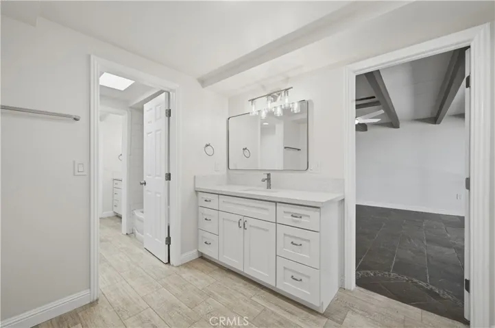 1 bath vanity fully remodeled and all new w plank tile flooring, self closing cabinets, custom faucet fixtures, mirror and custom lighting.