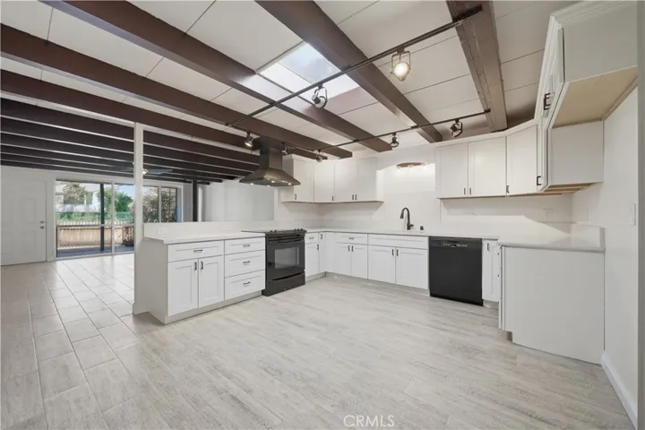 Large and open kitchen area w new self closing cabinets and quartz counterterops.