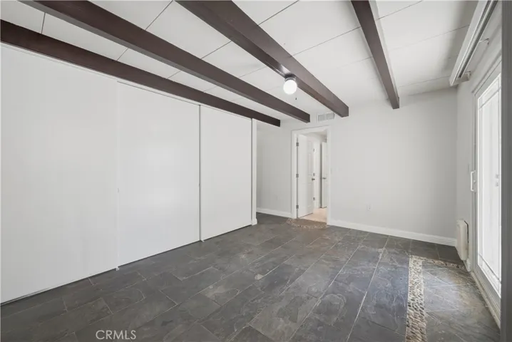 Reverse view of bedroom #2 w sliding closet doors to the left.