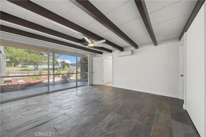 Reverse view of front bedroom w door leading to vanity area and secondary closet