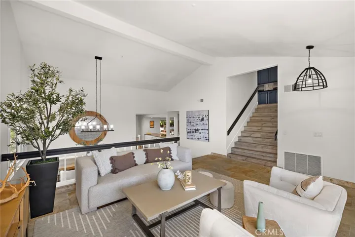 Extra wide staircase flows from the living room