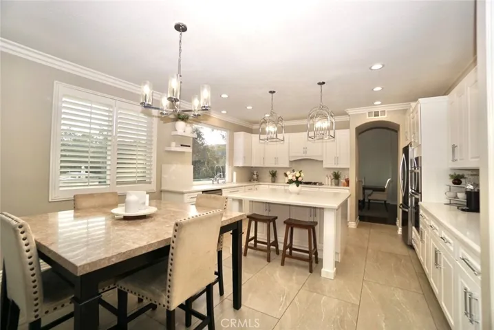 KITCHEN /NOOK SPACE WITH PRETTY PENDANTS & RECESSED LIGHTS