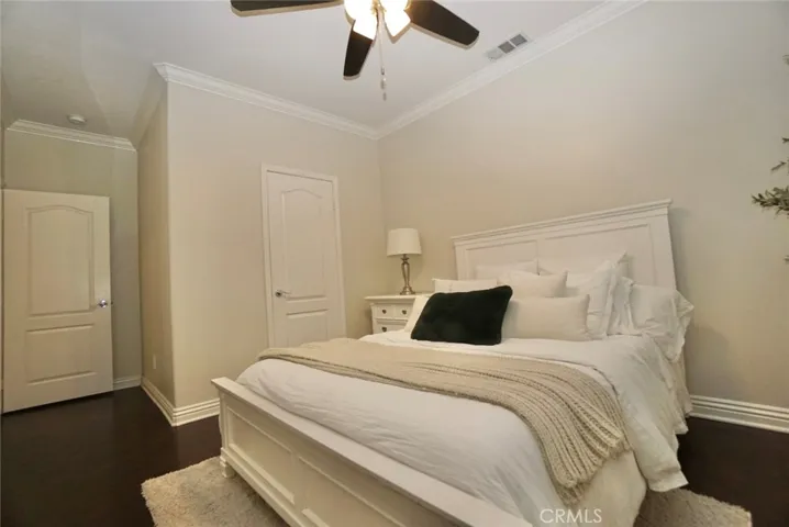 FIRST FLOOR BEDROOM INCLUDES CEILING FAN & CROWN MOLDING & LARGE BASEBOARDS