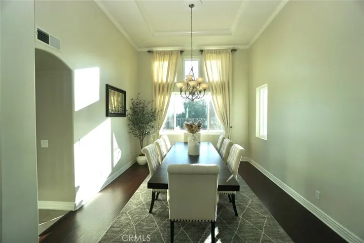 FORMAL DINING ROOM W/LAMINATED FLOORS & CEILING WITH CROWN MOLDING