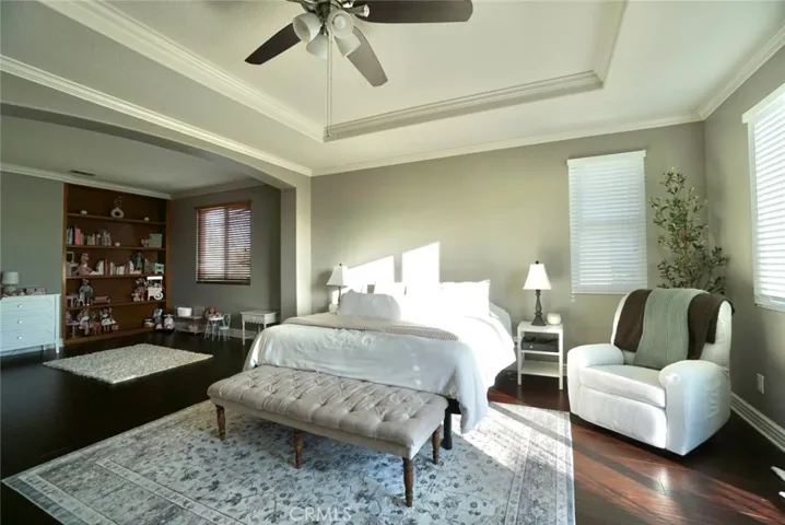 EXTENSIVE MASTER BEDROOM SUITE WITH DECORATIVE CEILING OPEN TO A SITTING/NURSING ROOM