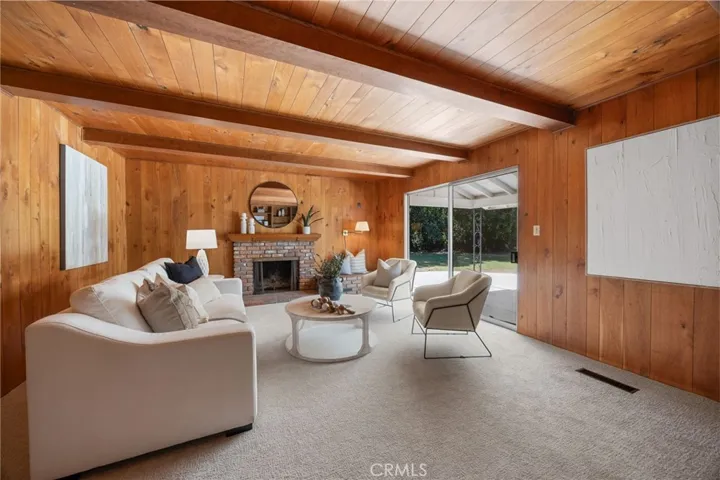 Rich wood paneling in the den creates a warm, inviting atmosphere—ideal for a quiet retreat, study, or media space.