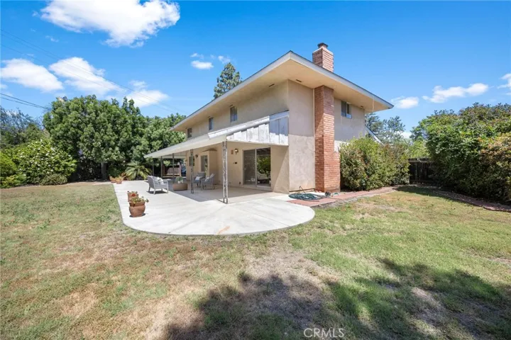 Private backyard surrounded by mature landscaping, creating a peaceful and secluded setting.
