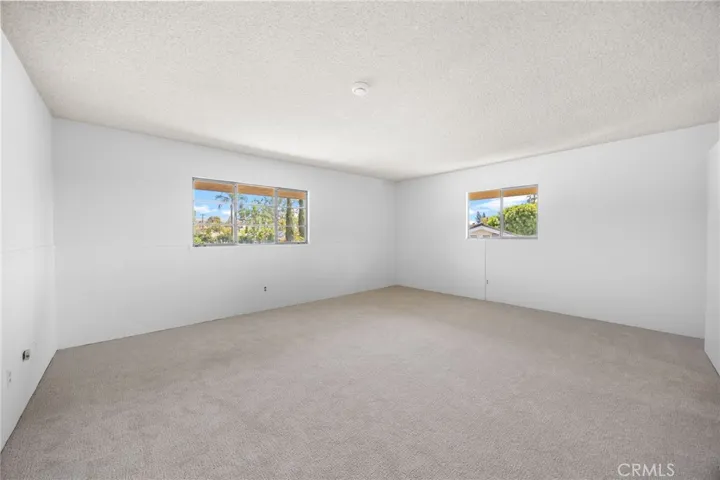 Upstairs, the second of three light-filled bedrooms create bright and inviting living spaces.