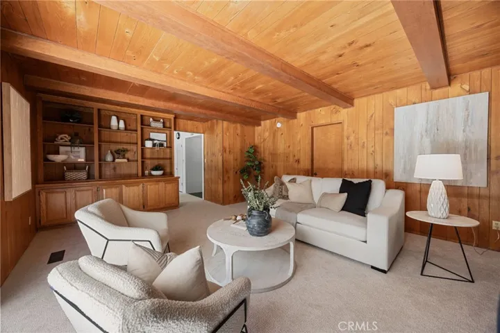 The paneled den adds a layer of warmth and charm, with the potential to preserve its character or redo it to suit your design vision.