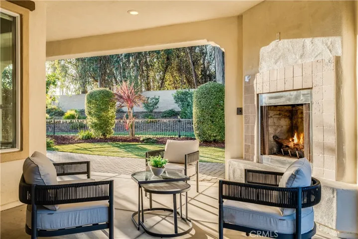 Outdoor covered patio with fireplace.